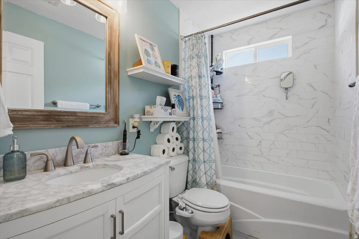 White vanity with brushed nickel hardware, set against a light blue wall