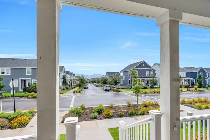 Covered porch with white railings and columns
