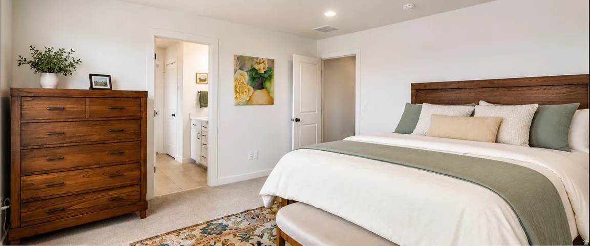 White walls with recessed lighting and light-toned carpeting