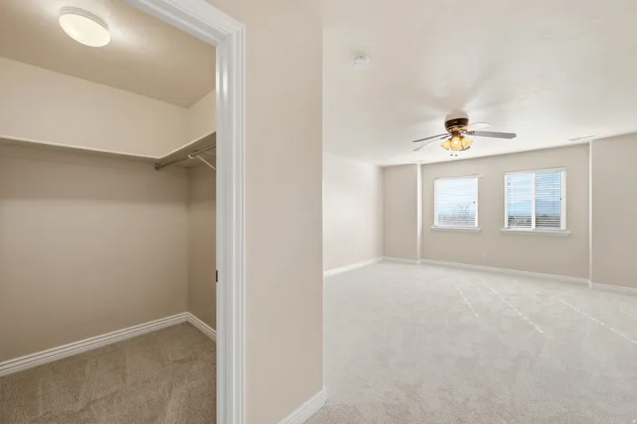 Spacious room with light-toned carpeting and multiple windows