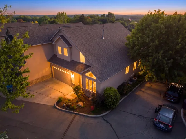 Multi-level exterior with a prominent attached garage and multiple windows