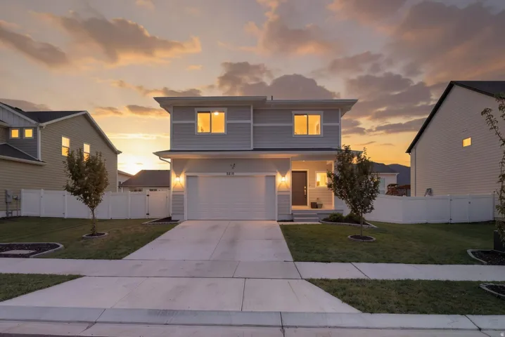 Contemporary two-story exterior with horizontal siding, an attached two-car garage, and a concrete driveway