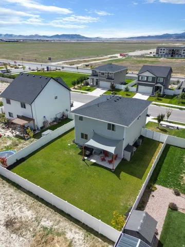 Fenced backyard with a concrete patio,