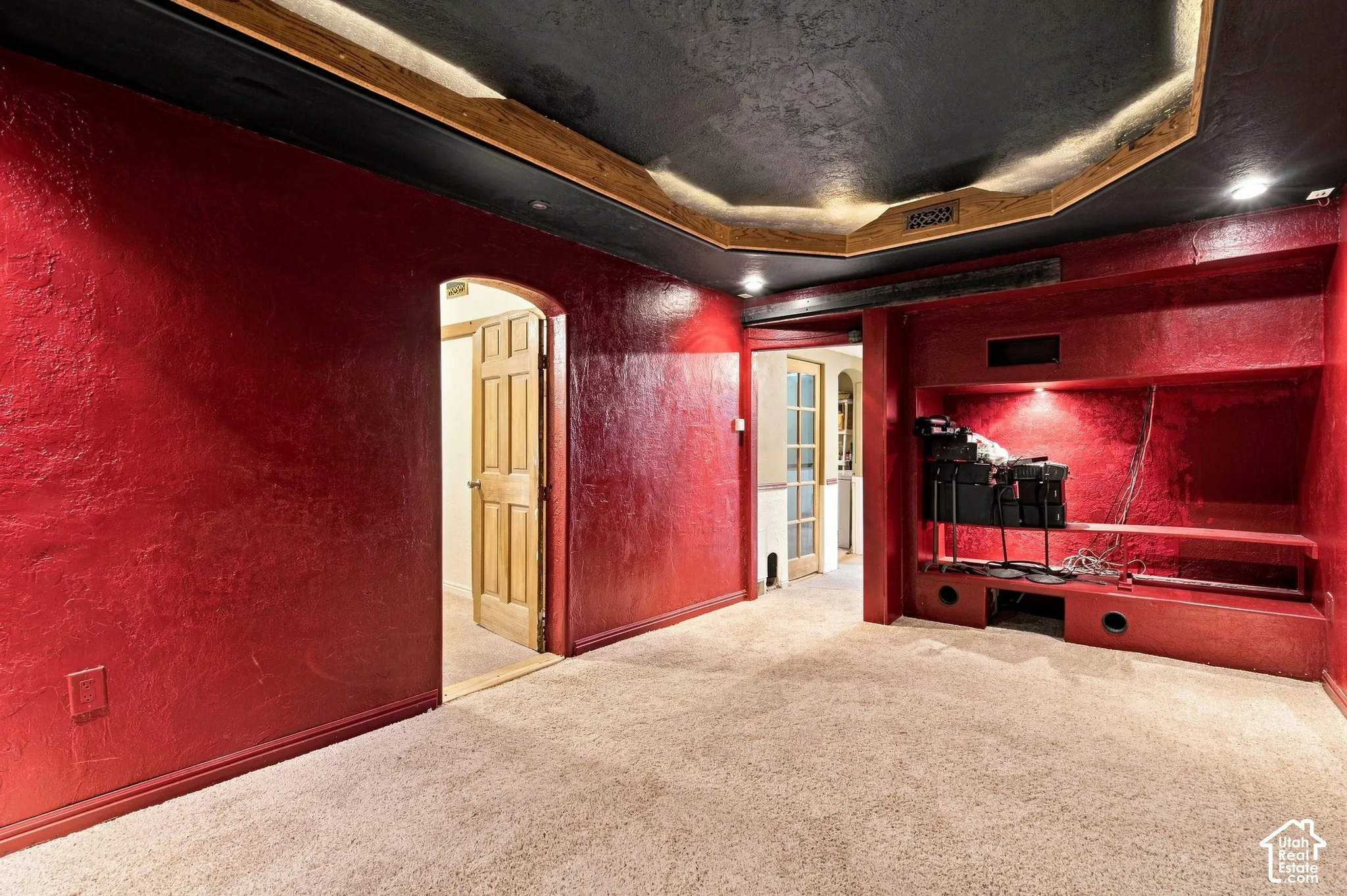 Theatre room facing hallway and entrance to a bedroom