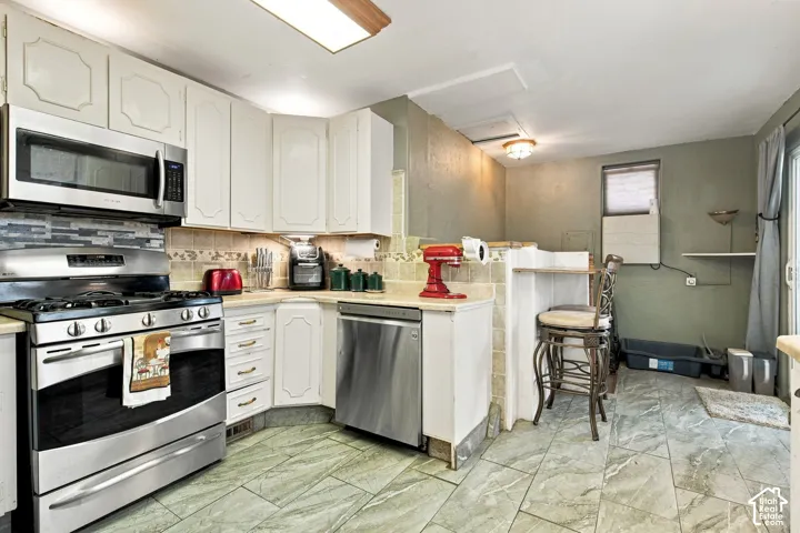 Kitchen facing stairs to basement