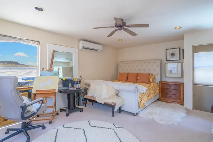 Room featuring recessed lighting, a ceiling fan, window, and wall-mounted climate control unit