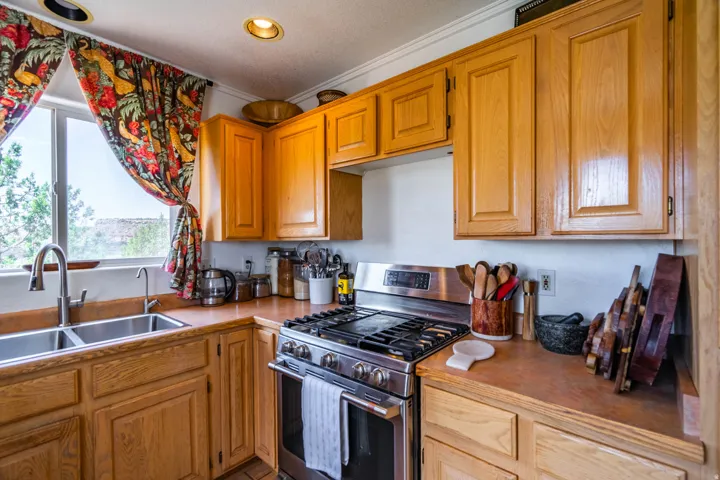 Wood-finish cabinetry paired with a stainless steel gas range