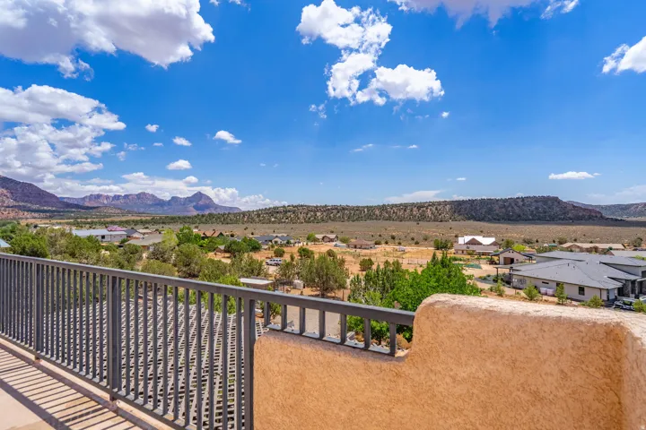 Balcony with metal railing and stucco-finish wall