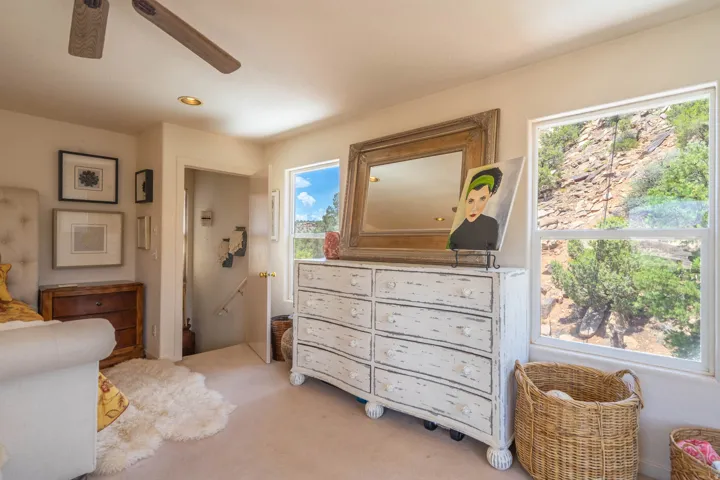 Recessed lighting, ceiling fan, and multiple windows providing natural illumination