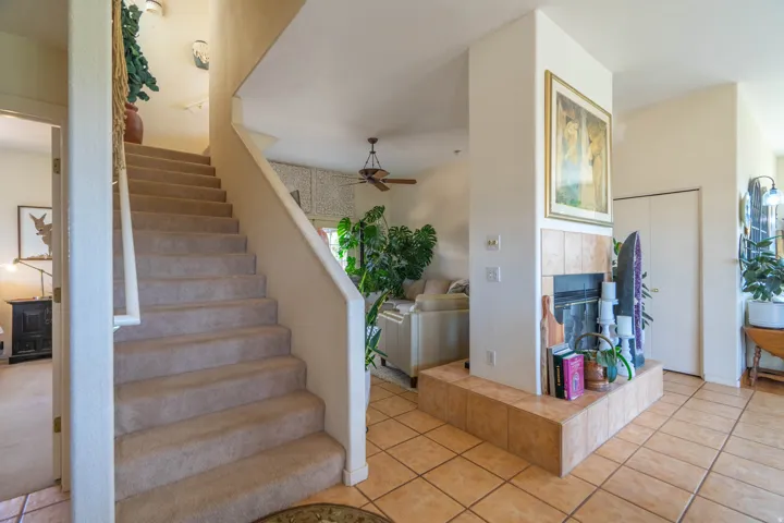 Carpeted staircase with white railing