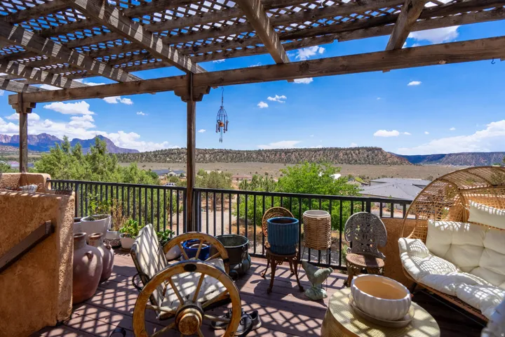 Covered pergola with panoramic vistas of forested terrain and distant plateaus