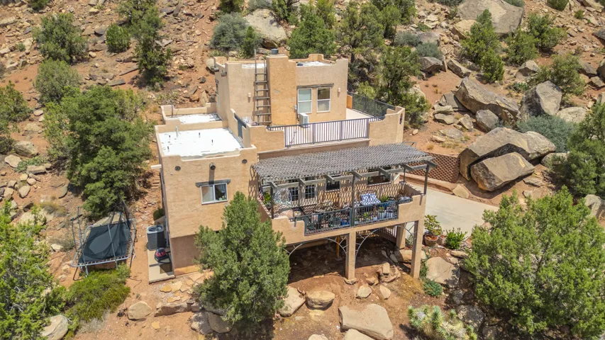 Multi-level stucco exterior with multiple outdoor living areas