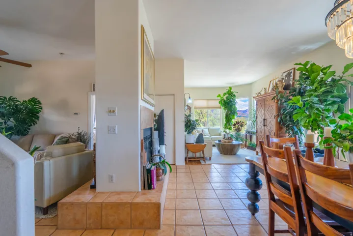 Tile flooring extends into the living area, featuring a built-in fireplace with a tiled hearth and surround