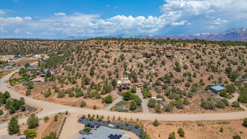 Expansive desert landscape with natural rock formations and a distant mountain range