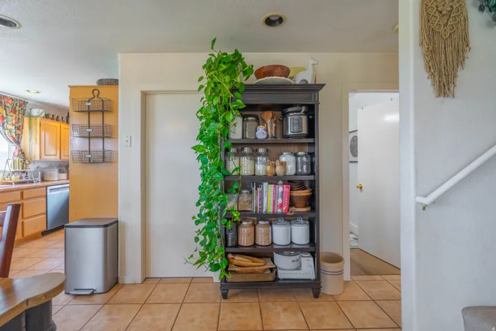 Kitchen featuring wood cabinetry, stainless steel dishwasher, and recessed lighting