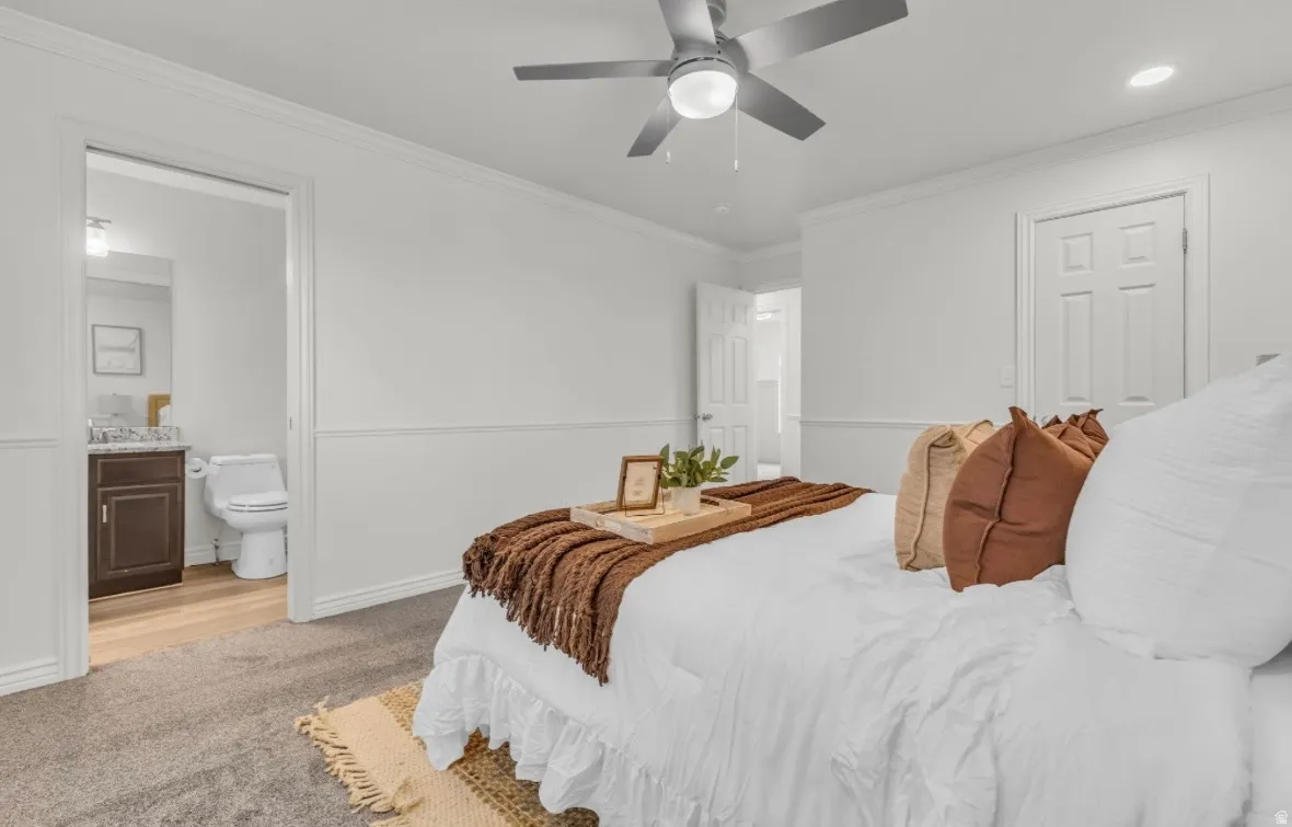 Recessed panel wainscoting, crown molding, and a ceiling fan with integrated lighting
