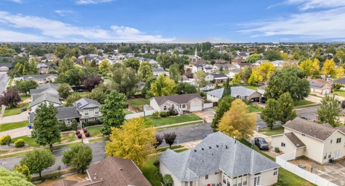 Established neighborhood featuring tree-lined streets and well-spaced residential properties with manicured lawns, mature landscaping, and varied architectural styles characteristic of a suburban community