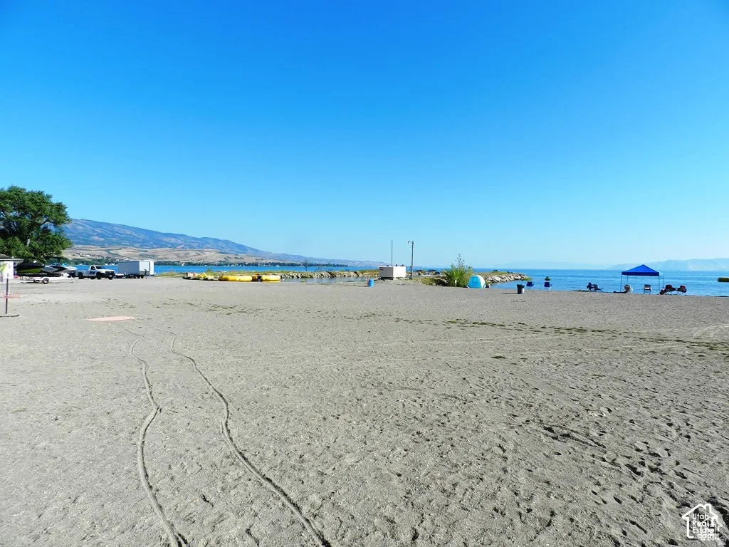 Expansive sandy beach with a clear body of water