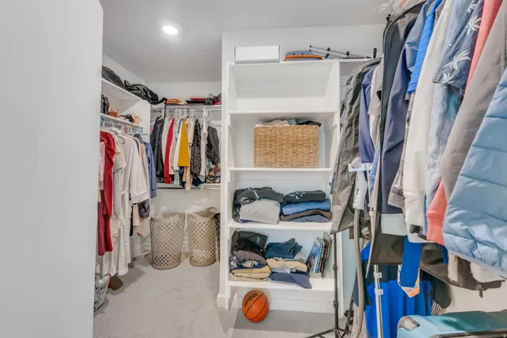Integrated closet shelving with hanging rods and recessed lighting