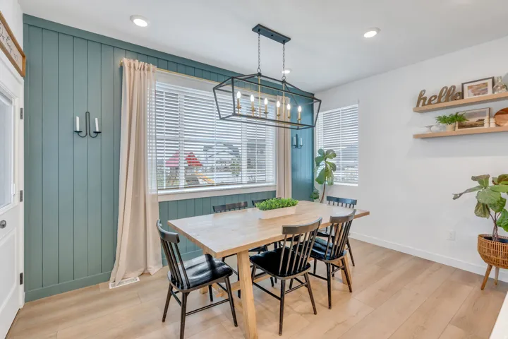 Wood-finish flooring, recessed lighting, and a linear chandelier