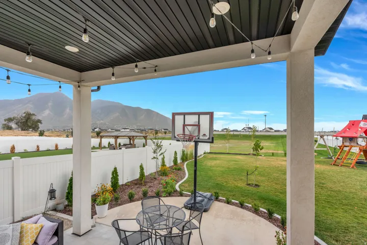 Expansive covered patio with recessed lighting and strung accent lights