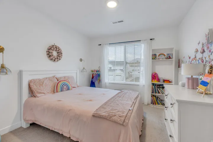 Recessed ceiling lighting, window with blinds, built-in shelving, carpeted flooring, and white walls