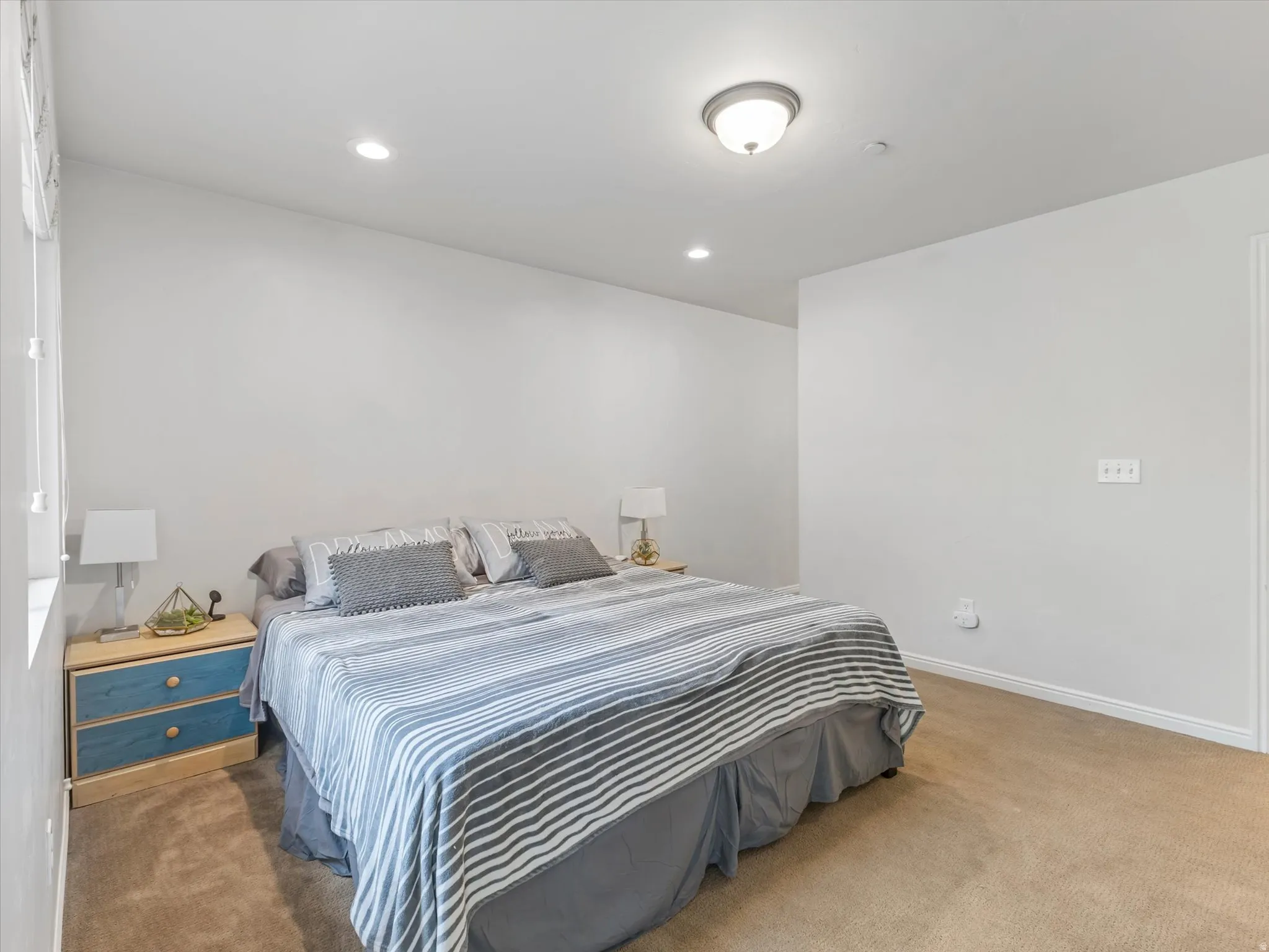Recessed lighting, flush mount ceiling fixture, window, and carpeting