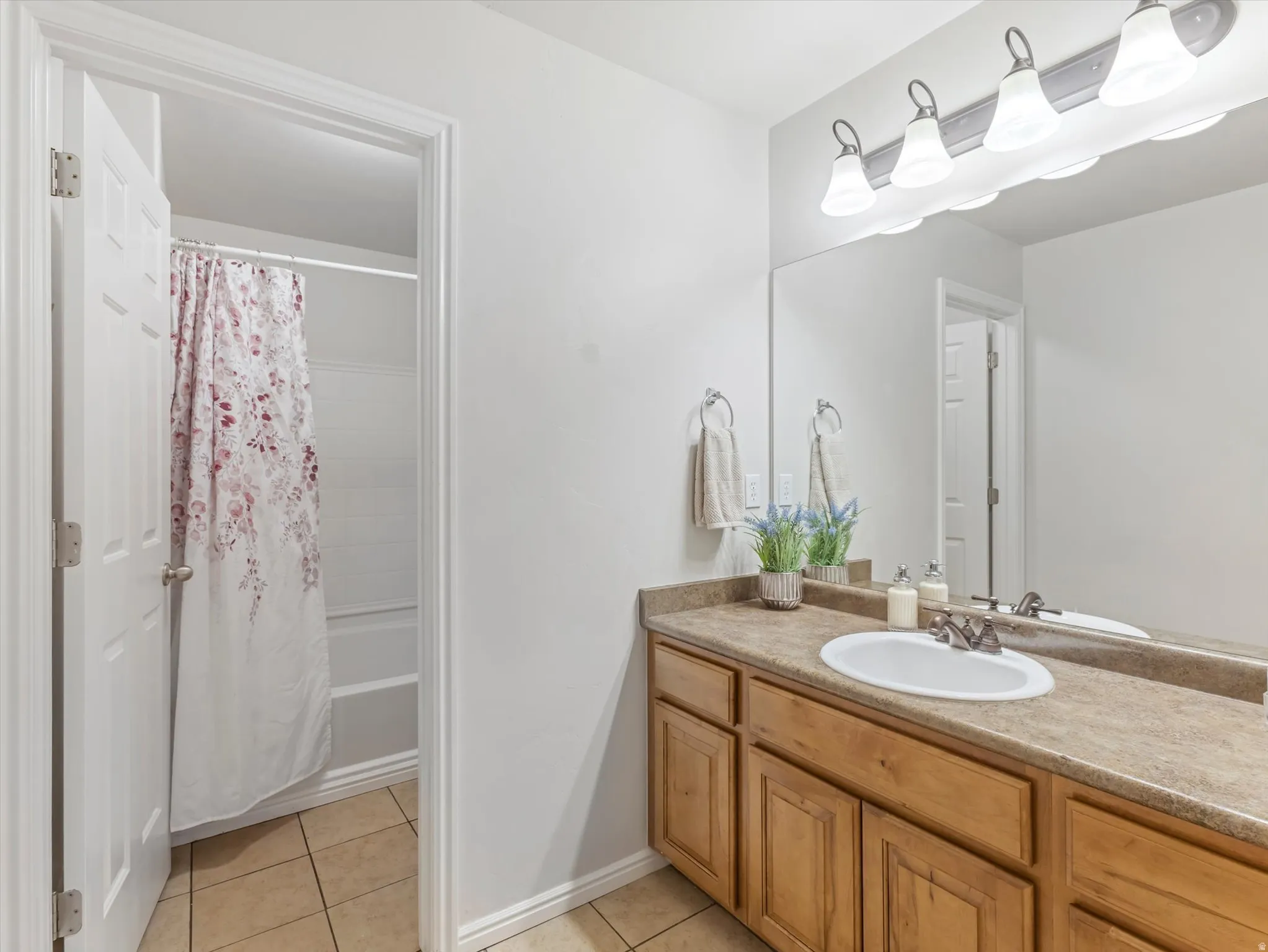 Wood-finish vanity with an integrated sink and chrome faucet