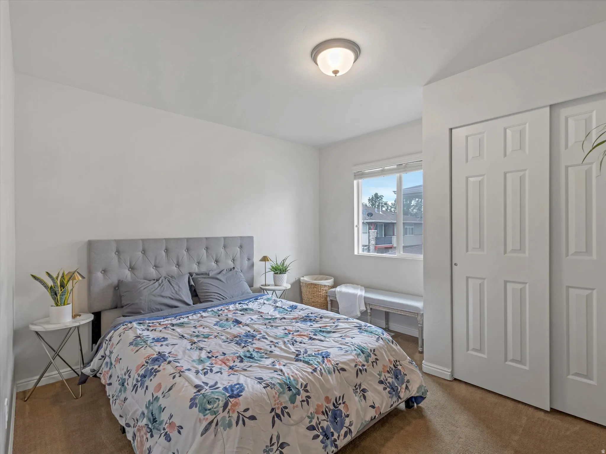 Recessed ceiling light fixture, single window with natural light, wood-finish flooring, and white panel bi-fold doors