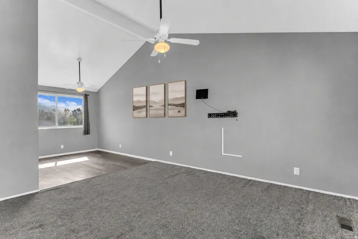 Vaulted ceiling with integrated lighting and dual ceiling fans