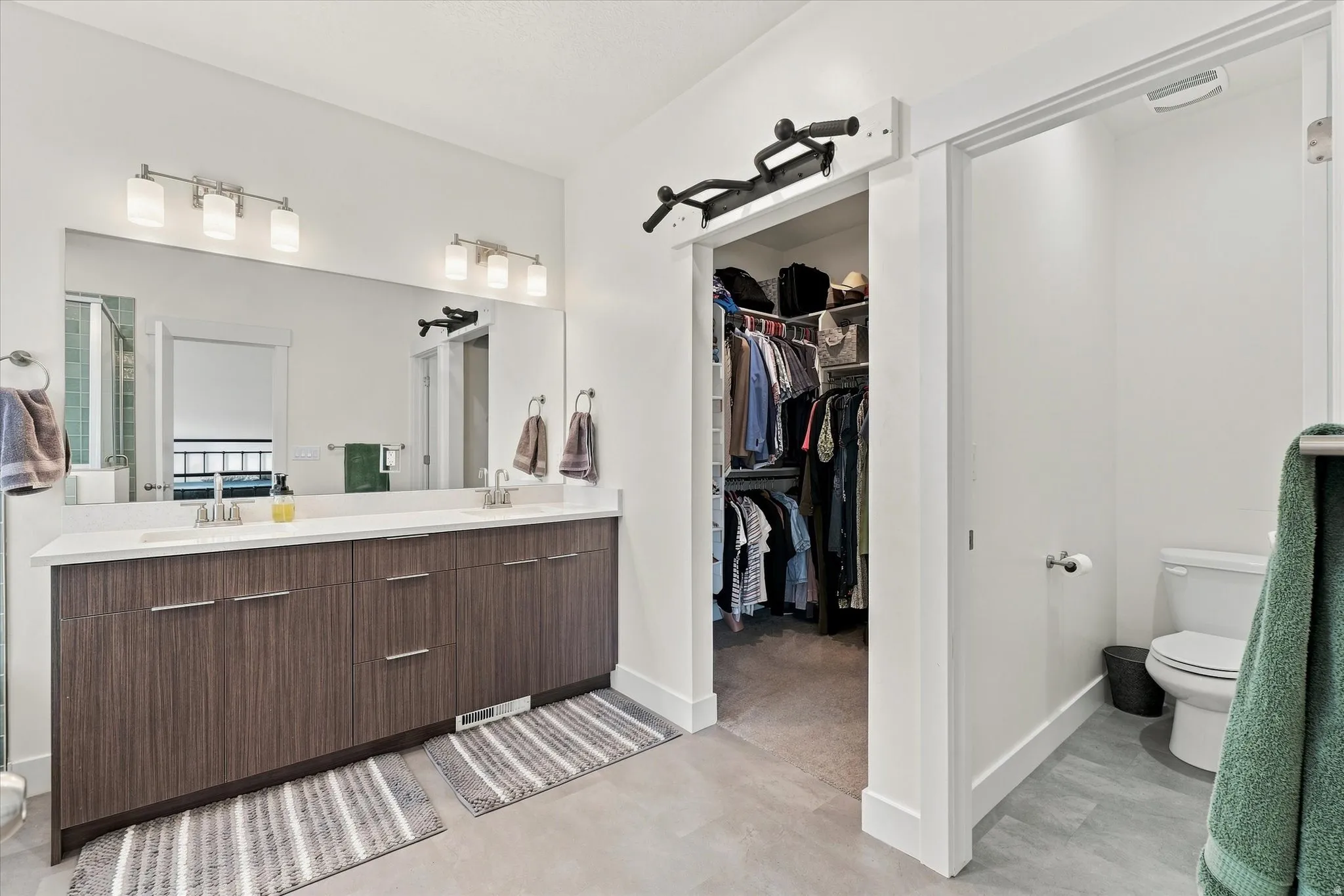 Dual sink vanity with wood-finish cabinetry and white countertop