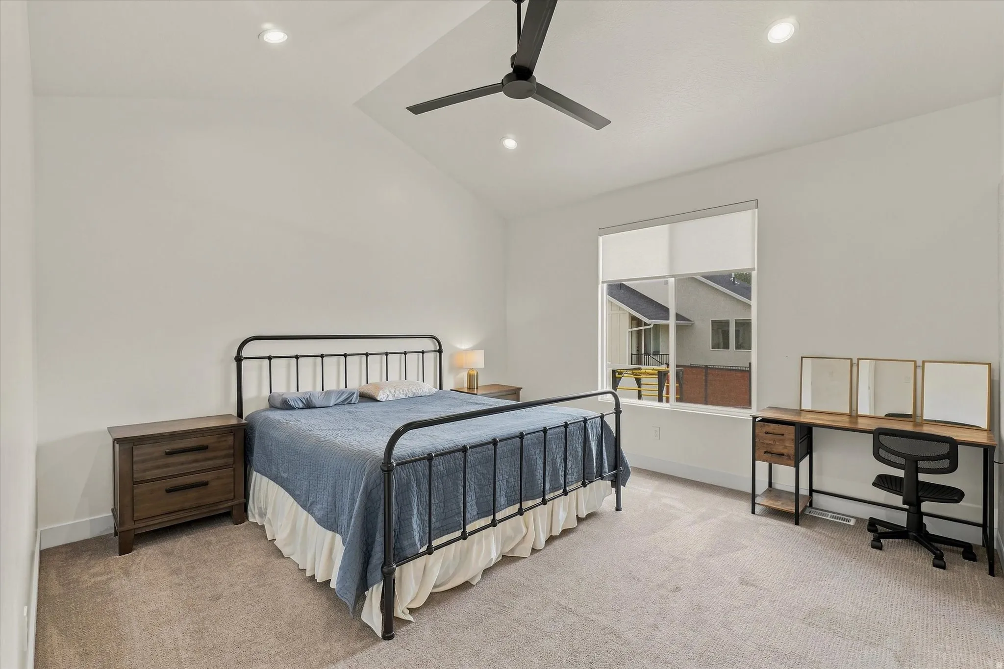 Vaulted ceiling with recessed lighting, ceiling fan, large window, and carpeted flooring