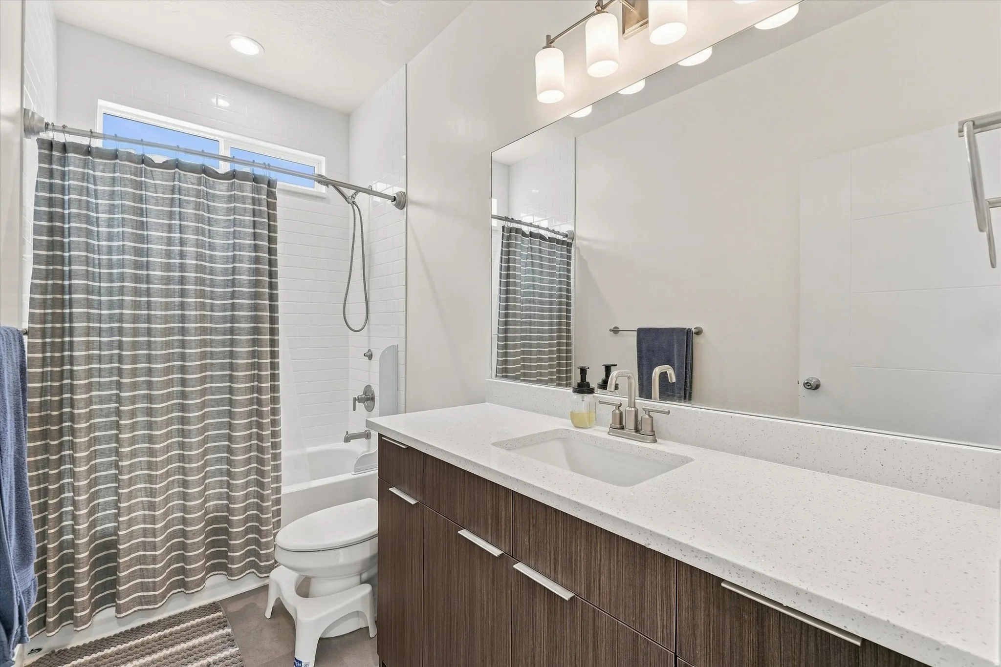 Modern vanity with an integrated sink and light-toned countertop