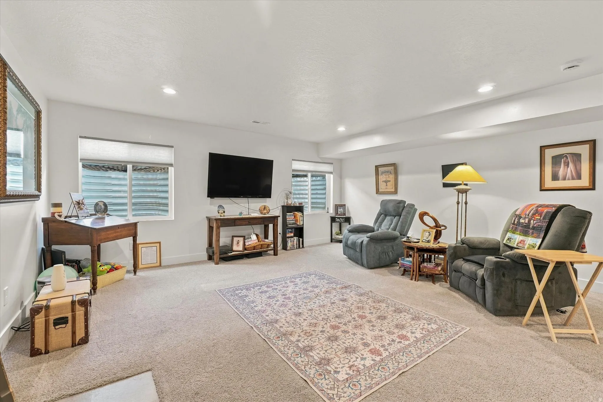 Recessed lighting, light-toned carpeting, multiple windows, and smooth wall finishes