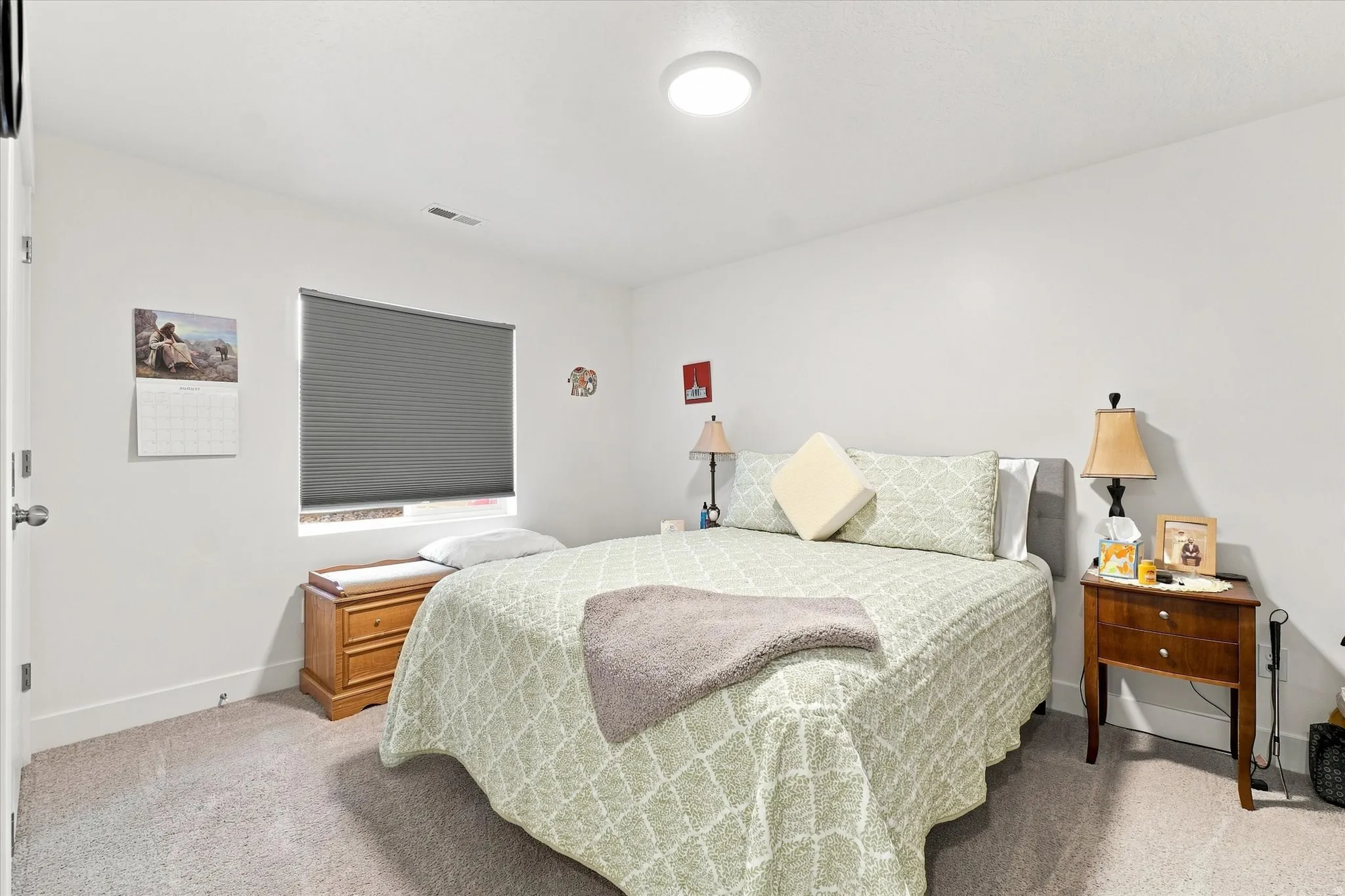 Neutral wall finishes, recessed window with cellular shade, flush-mount ceiling light, and carpeted flooring