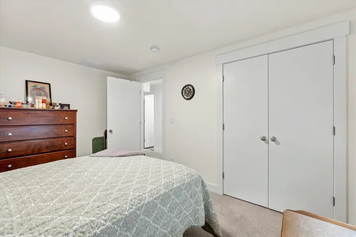 Recessed ceiling light, white paneled interior doors, and light-toned carpeting