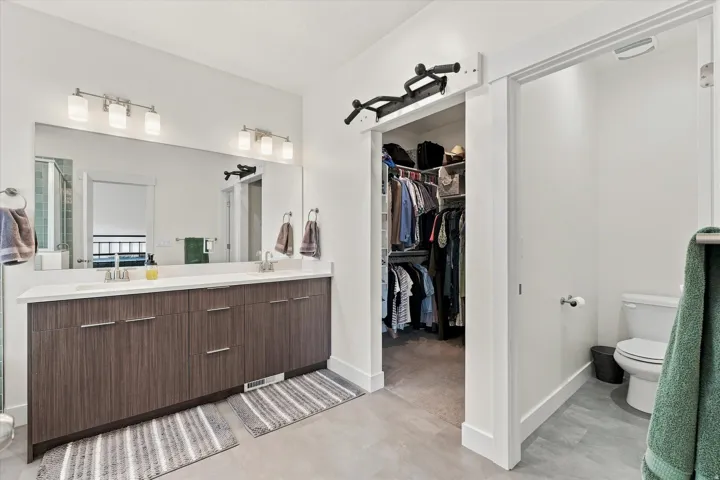 Dual sink vanity with wood-finish cabinetry and white countertop