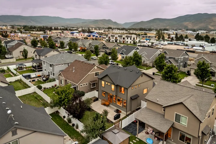 Residential neighborhood with a mountain backdrop and a mix of single-family homes and multi-story buildings