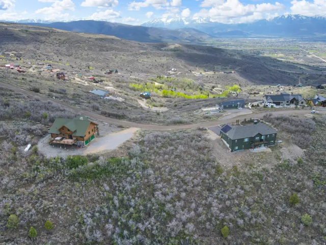Mountainous landscape with scattered properties and distant snow-capped peaks