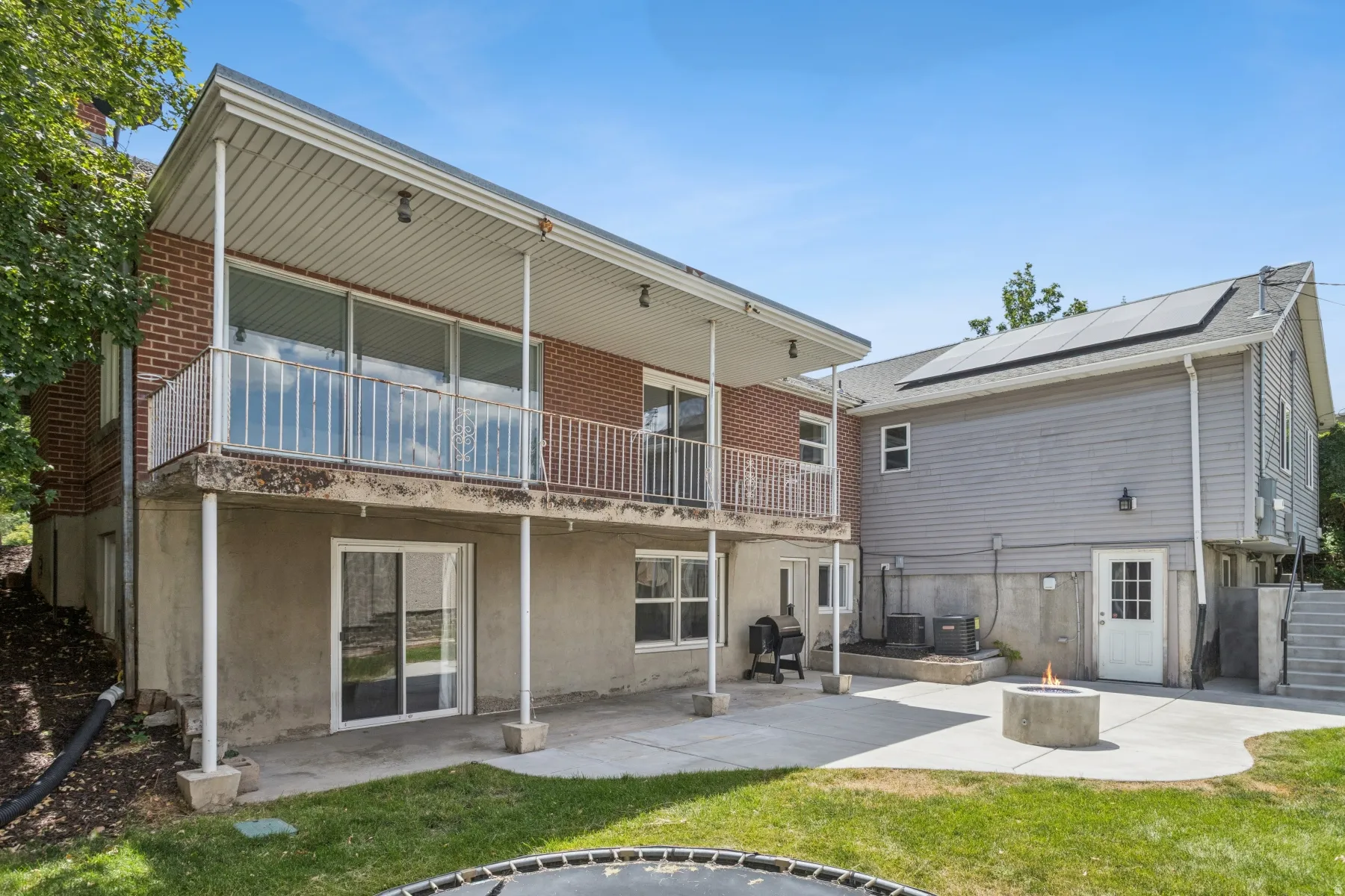 Expansive concrete patio with a built-in fire pit
