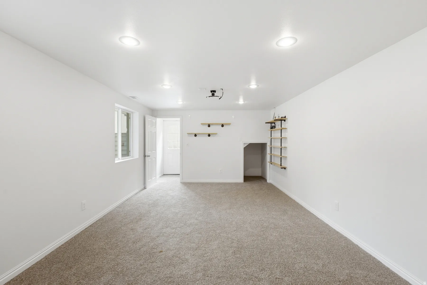 Recessed ceiling lighting, projection unit, built-in shelving, under-stair storage, and window