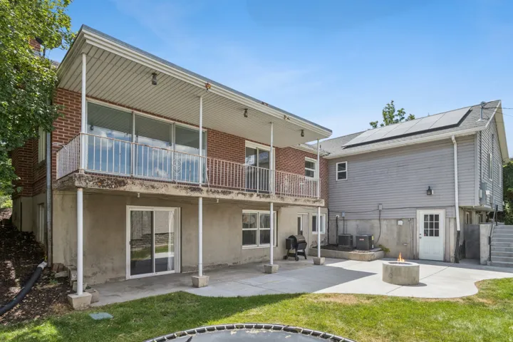 Expansive concrete patio with a built-in fire pit