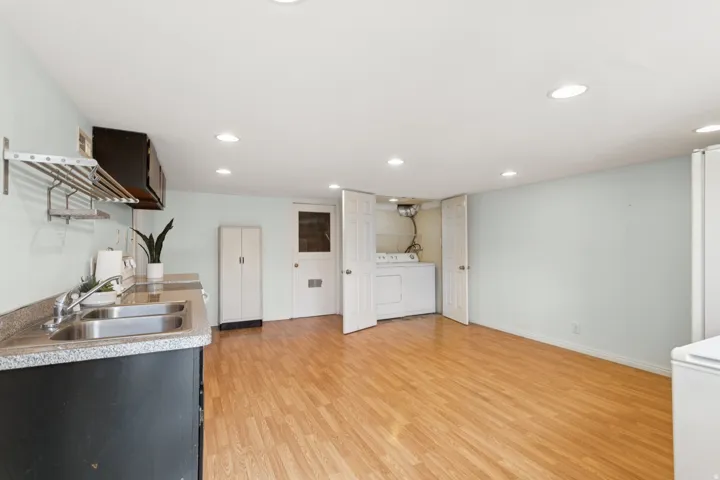 Built-in kitchenette with a double basin stainless steel sink and laminate countertop