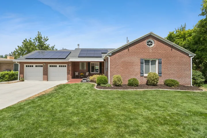 Brick exterior with a gabled roof and round accent window