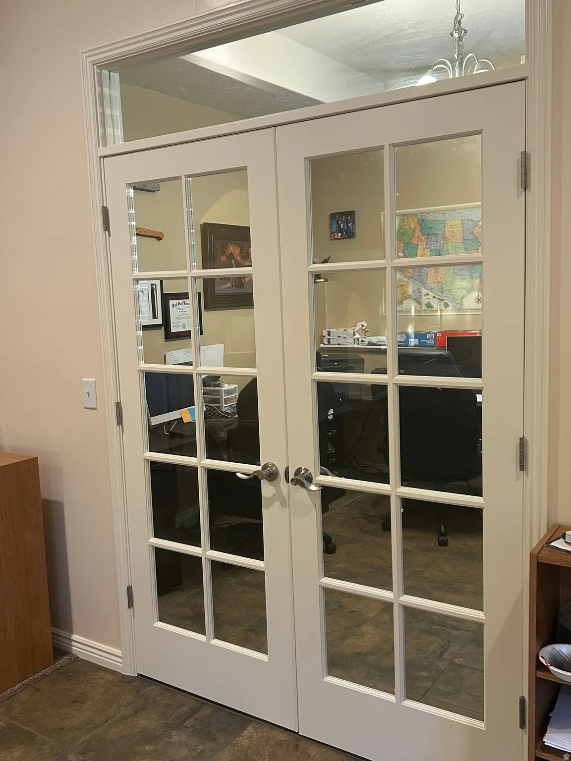White French doors with clear glass panes, transom window, and brushed nickel hardware