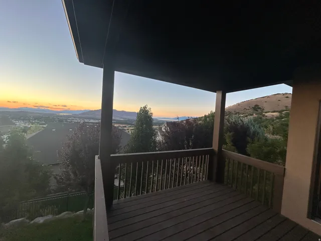 Covered outdoor deck with wood-finish decking and railing
