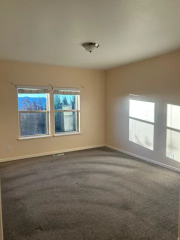 Recessed lighting, neutral-toned walls, and carpeted flooring