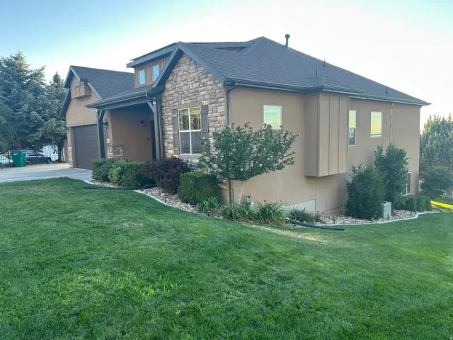 Stucco and stone exterior with architectural shingles