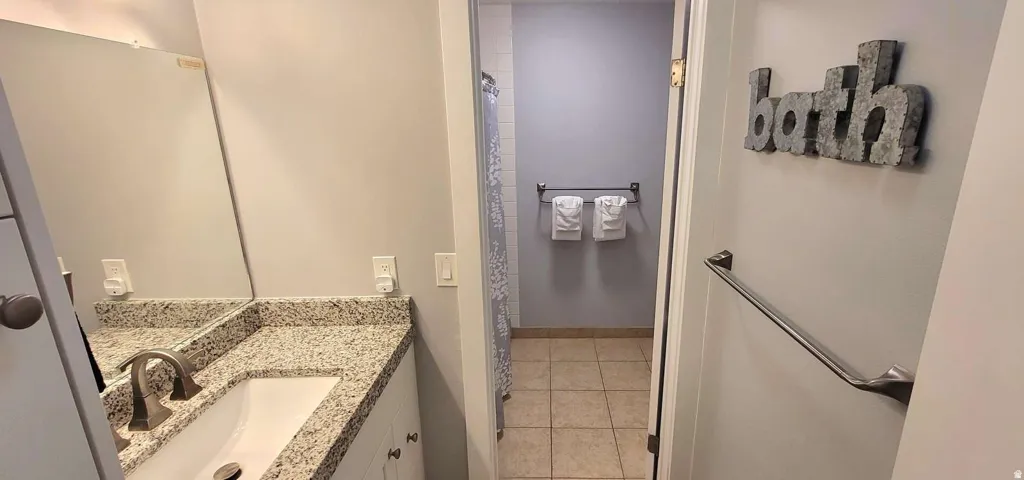 Vanity with a speckled countertop and an undermount sink