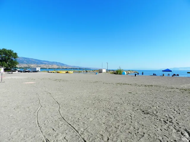 Expansive sandy beach with a clear body of water
